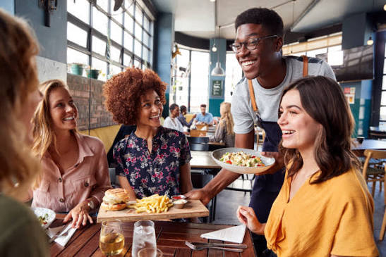 A server at the table with guests, taking an order without having to walk back to the kitchen