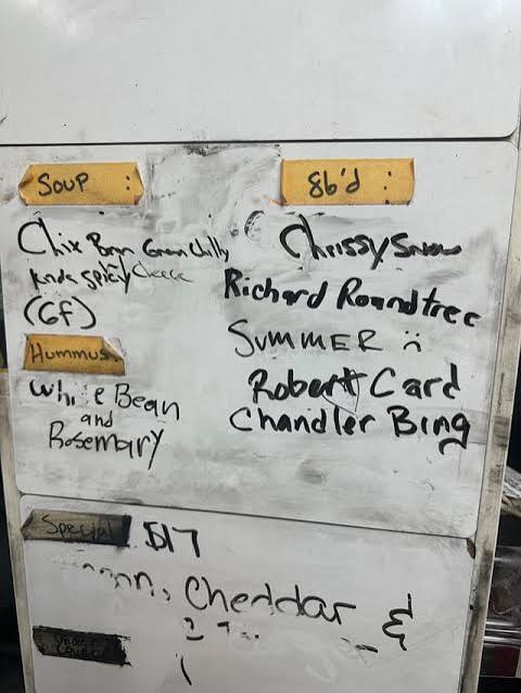 A dry-erase board carrying the night’s 86 list